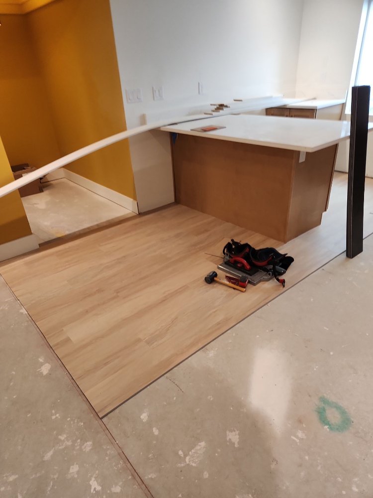 Basement bar area remodel by RemodelCo in Daybreak, UT with new flooring, cabinetry, and quartz countertops in progress.-optimized