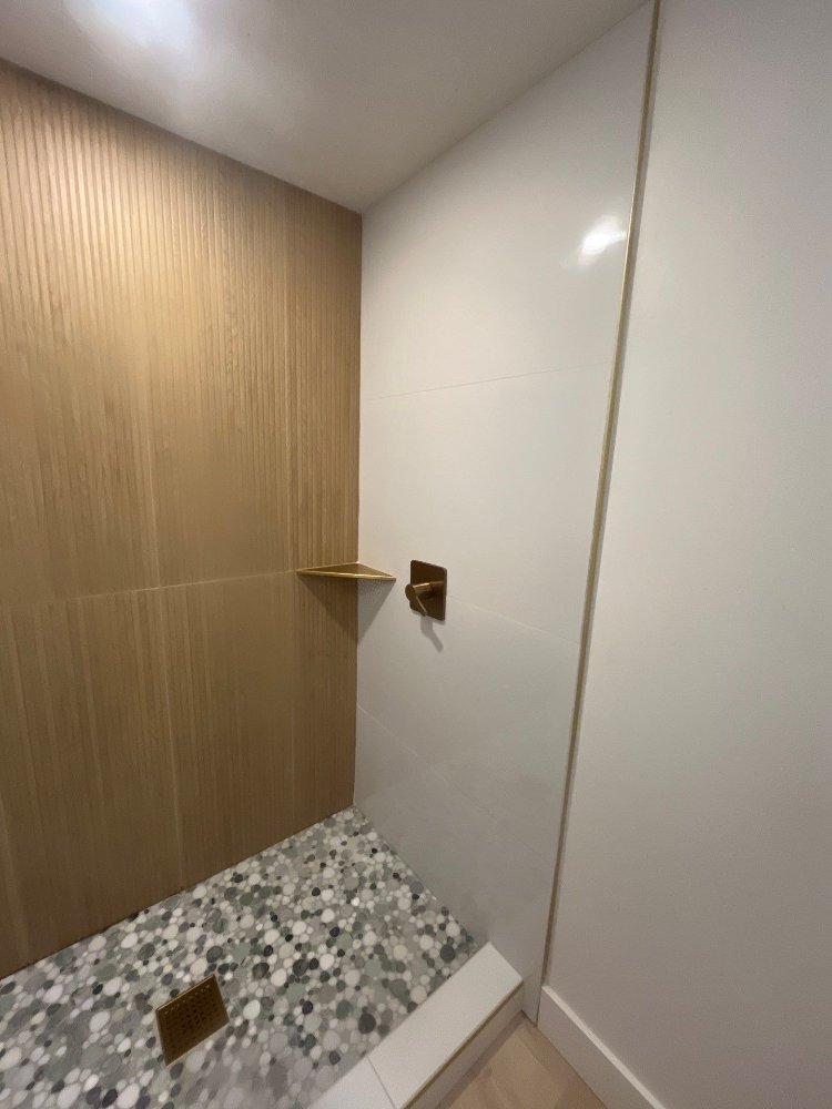 Basement bathroom shower detail showcasing premium tile installation by RemodelCo in Daybreak, UT.-optimized