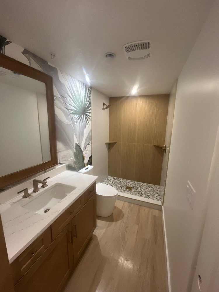 Completed basement bathroom with custom vanity, walk-in shower, and designer finishes by RemodelCo in Daybreak, UT.-optimized