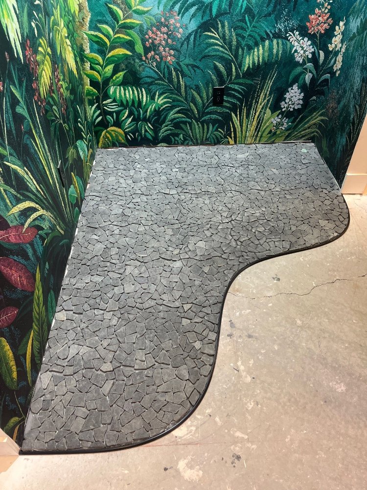 Completed custom black mosaic tile floor feature installed by RemodelCo during a basement finish in Daybreak, UT.-optimized