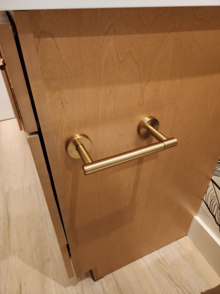 Detailed view of basement bar cabinetry by RemodelCo in Daybreak, UT showcasing modern brass pulls and quality craftsmanship.-optimized