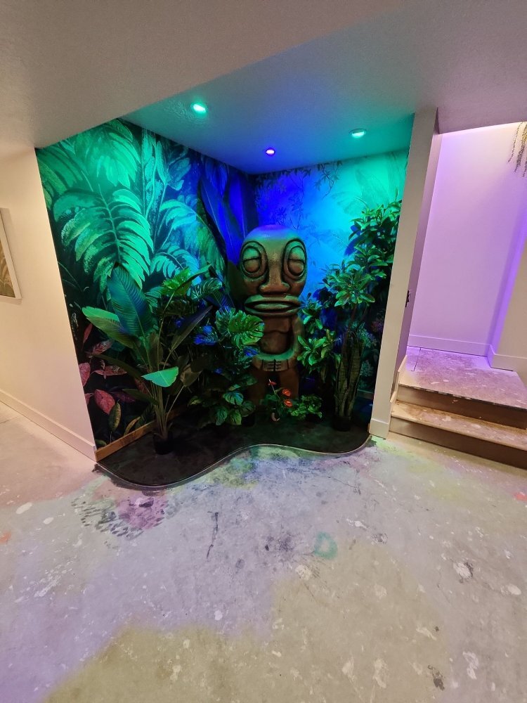 Finished basement recreation space in Daybreak, UT by RemodelCo with custom mural artwork and themed decorative features.-optimized