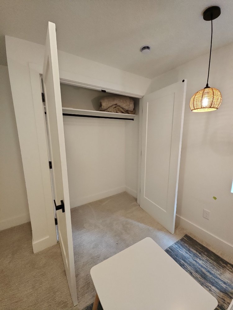 Functional basement storage closet featuring modern finishes from a RemodelCo basement renovation in Daybreak, UT.-optimized