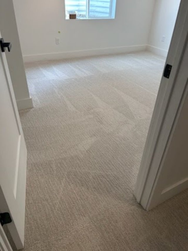 Newly finished basement bedroom with soft neutral carpet installed by RemodelCo as part of a basement finishing project in Daybr-optimized