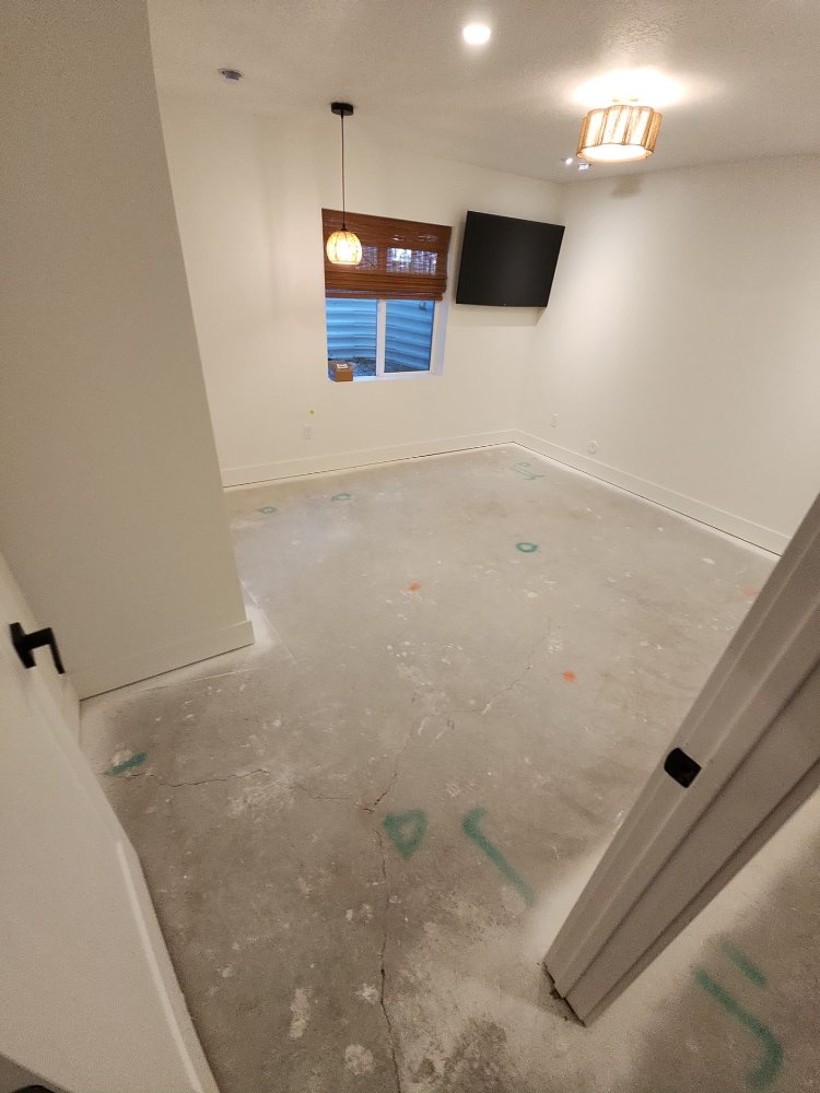 RemodelCo basement bedroom finish in Daybreak, UT featuring modern lighting, custom window treatments, and entertainment setup.-optimized