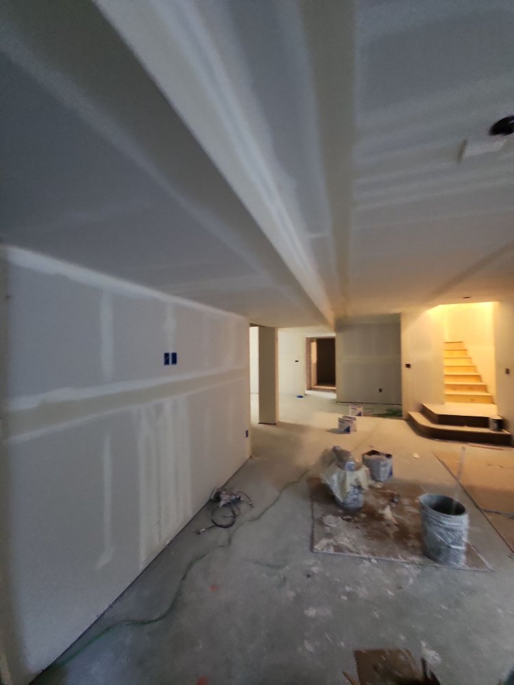RemodelCo basement finish in Daybreak, UT featuring a spacious entertainment area during drywall and finishing stages.-optimized