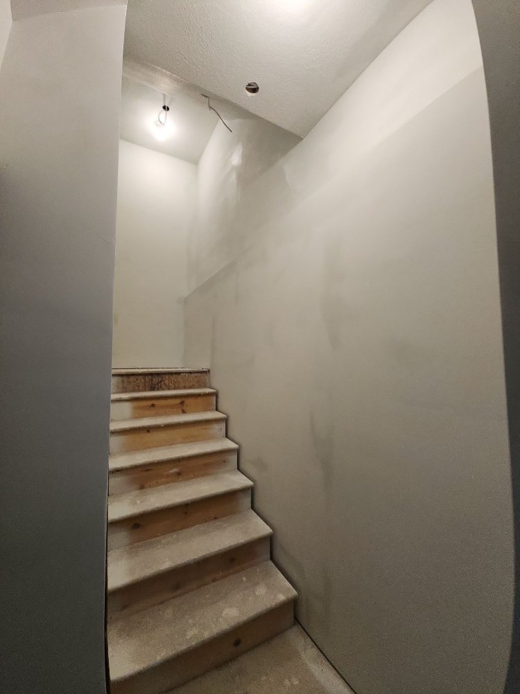 RemodelCo basement finish in Daybreak, UT showing newly framed and drywalled stair access under construction.-optimized