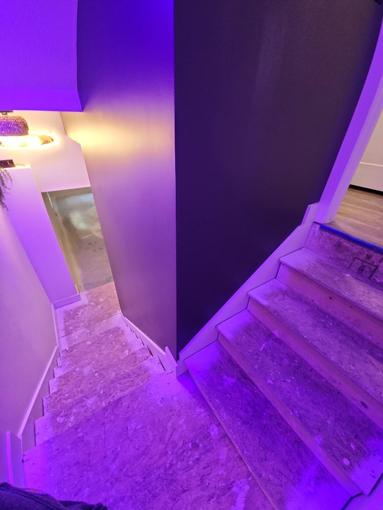 RemodelCo basement stairway renovation in Daybreak, UT featuring modern accent lighting and bold contemporary wall finishes.-optimized