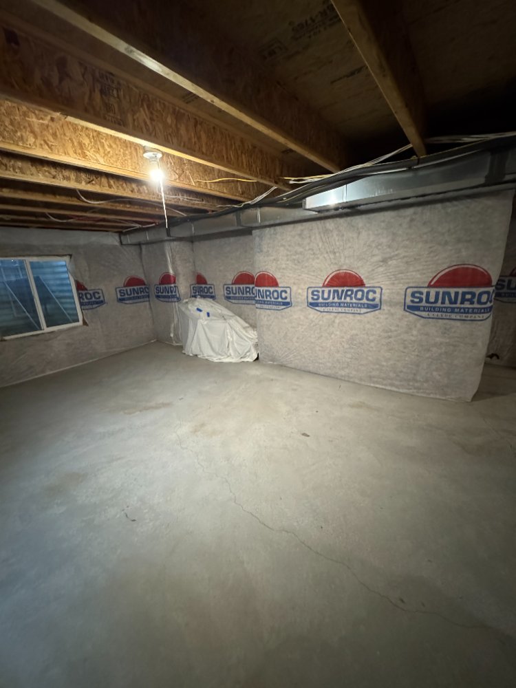 Unfinished basement area in Daybreak, UT prior to remodeling by RemodelCo featuring open floor space and exposed utilities.-optimized
