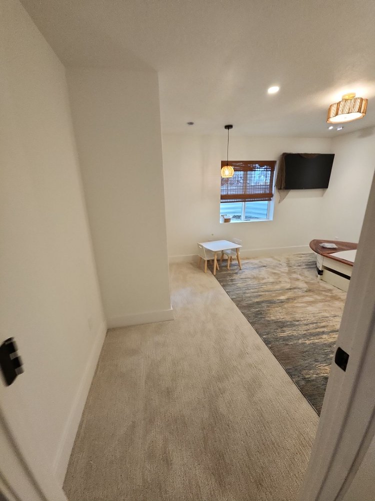 Unique basement remodel by RemodelCo in Daybreak, UT showcasing a jungle-inspired feature wall and immersive design details.-optimized