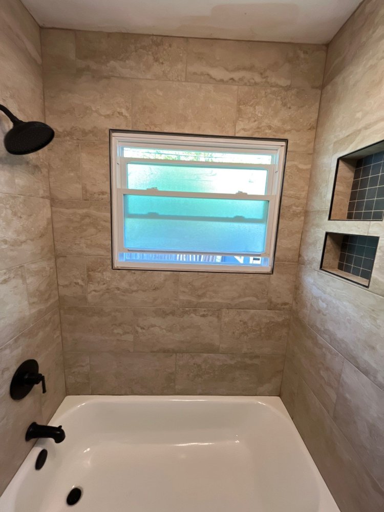 Bathroom remodel by RemodelCo in Salt Lake City, UT featuring a tiled bathtub surround with built-in storage niches and modern b-optimized