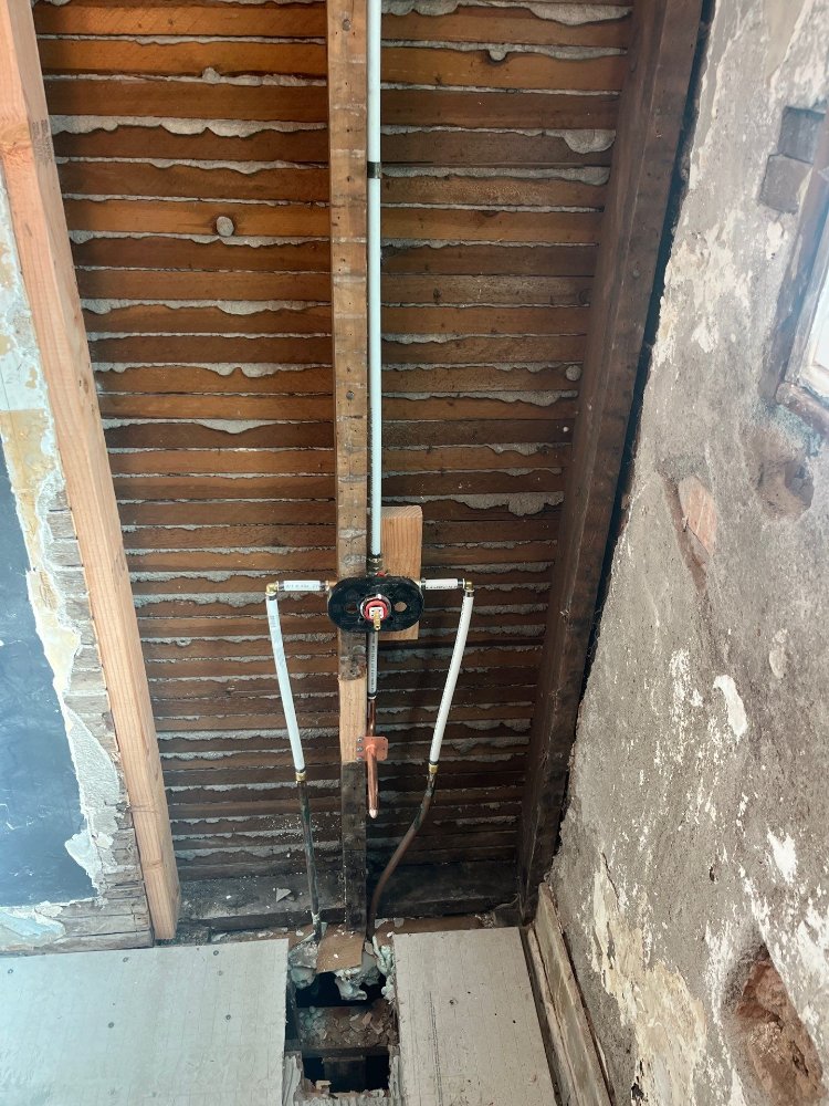 Bathroom remodeling project by RemodelCo in Salt Lake City, UT showing new plumbing installed for a tub and shower upgrade.-optimized