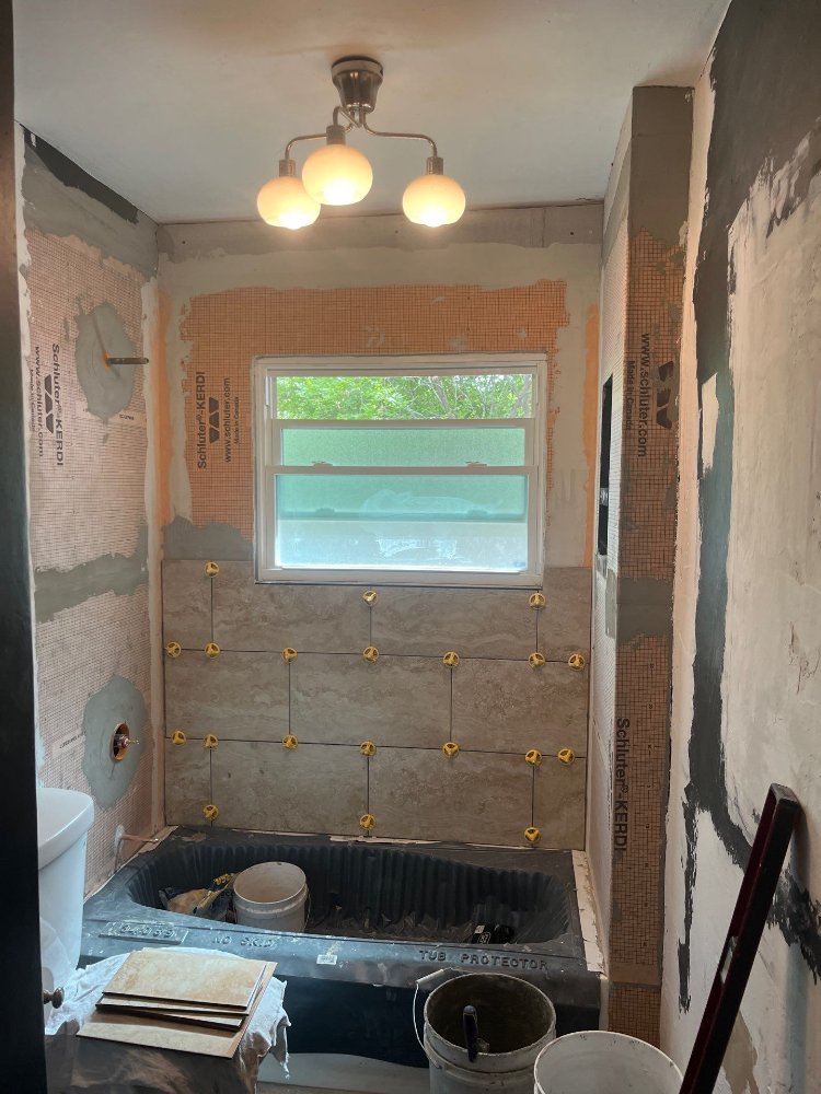 Bathroom renovation by RemodelCo in Salt Lake City, UT featuring tile installation over waterproof shower walls.-optimized