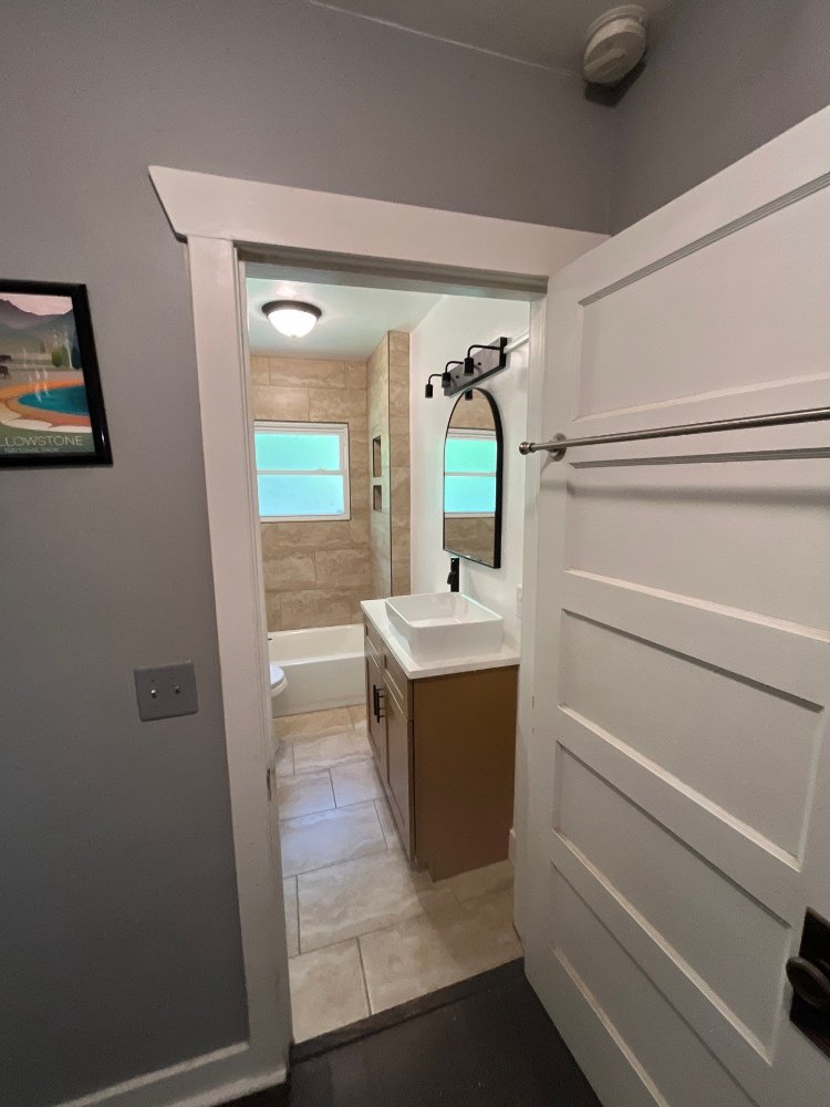Bathroom renovation completed by RemodelCo in Salt Lake City, UT showcasing contemporary fixtures, a new vanity, and tiled batht-optimized