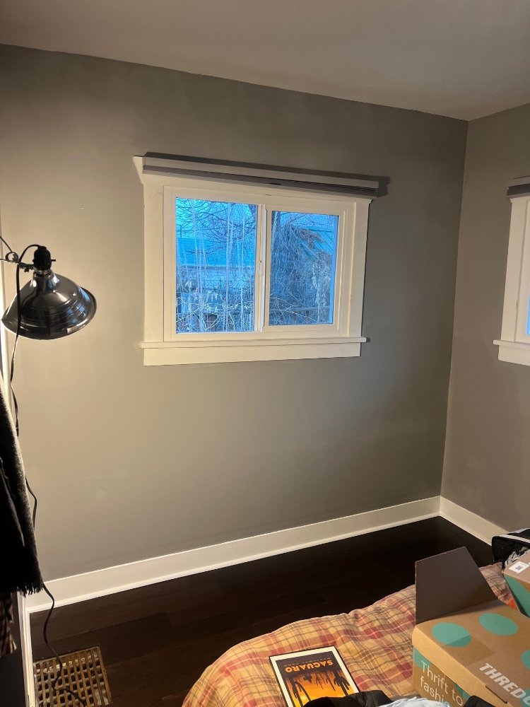 Finished bedroom wall and window trim after RemodelCo restoration project in Salt Lake City, UT.-optimized