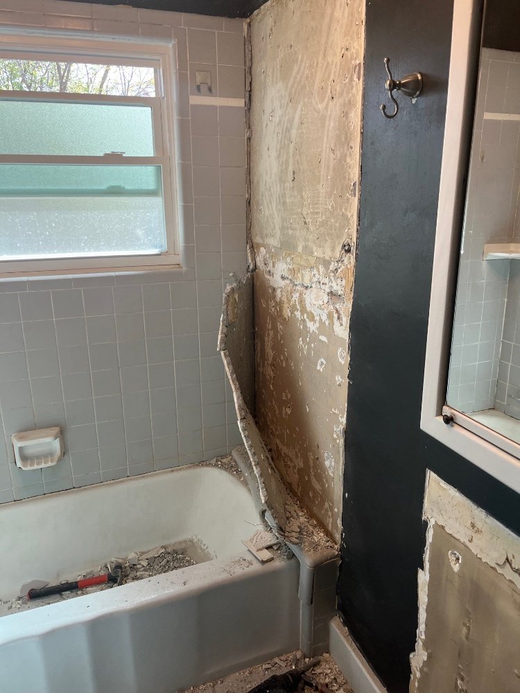 RemodelCo bathroom remodel demolition in Salt Lake City, UT showing bathtub surround wall removal and preparation for a custom b-optimized