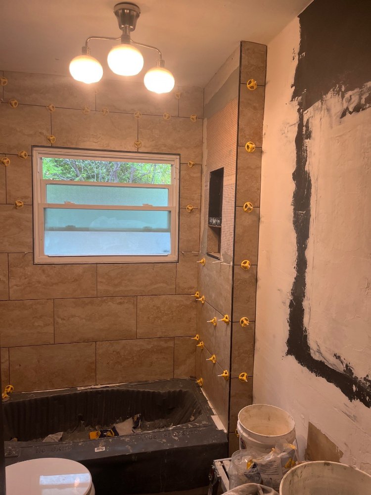 RemodelCo bathroom remodel in Salt Lake City, UT showing completed tub surround tile installation with recessed niche detail.-optimized
