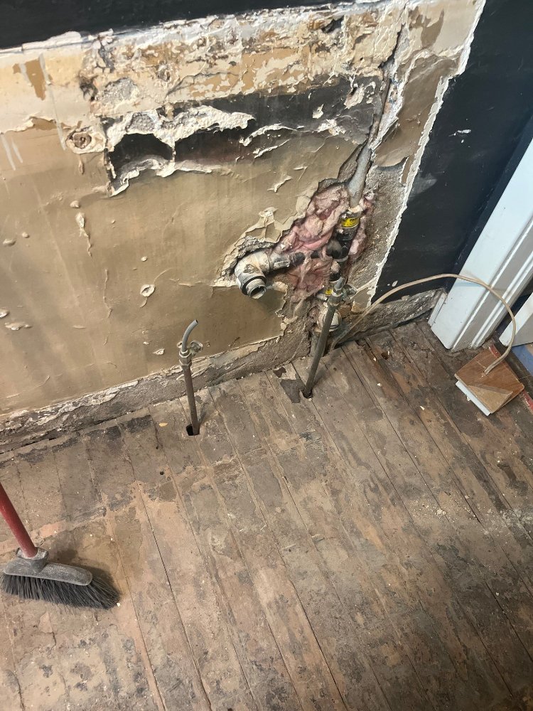 RemodelCo bathroom remodel in Salt Lake City, UT showing exposed plumbing connections and wall demolition before renovation.-optimized