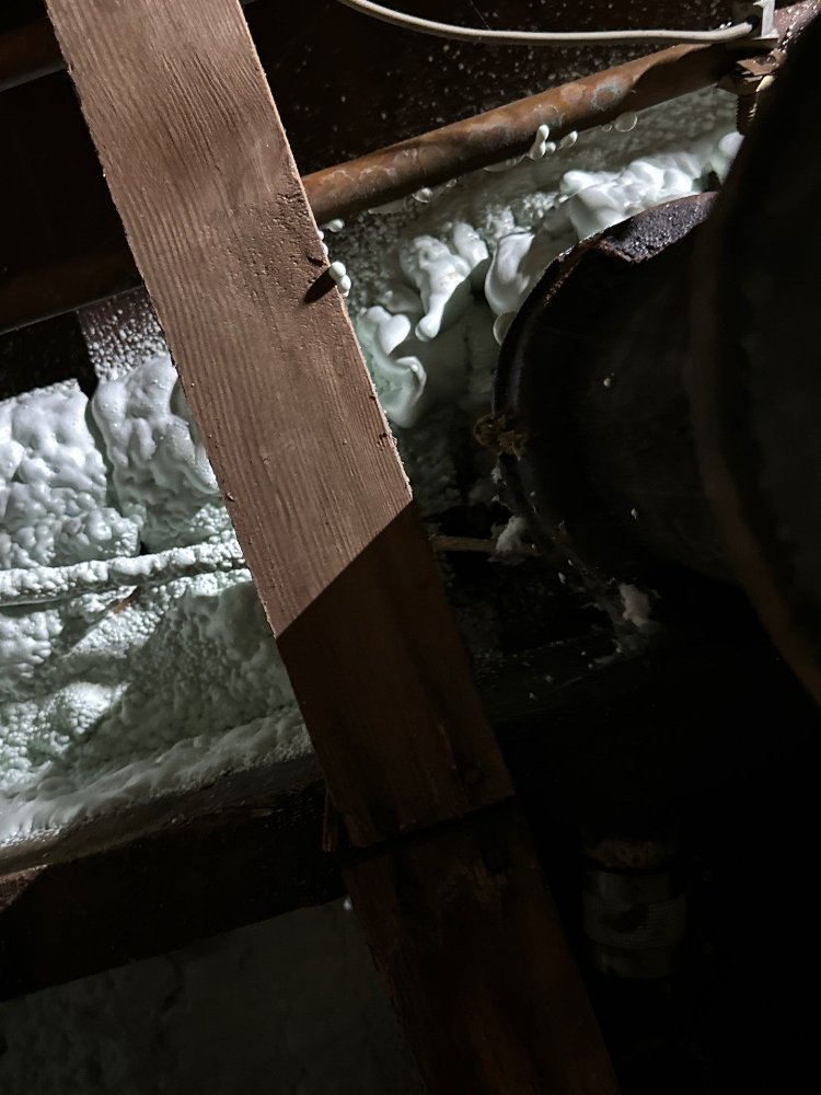 RemodelCo bathroom remodel project in Salt Lake City, UT showing crawl space framing, insulation, and plumbing infrastructure.-optimized