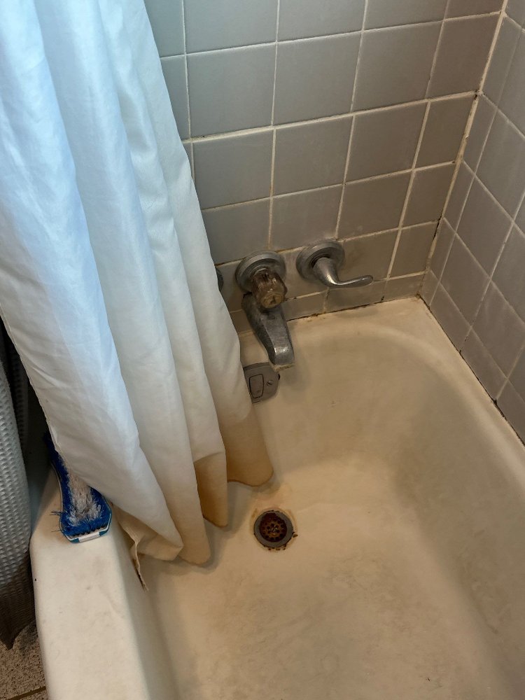 RemodelCo bathroom remodel project in Salt Lake City, UT showing the existing bathtub faucet and plumbing fixtures before renova-optimized