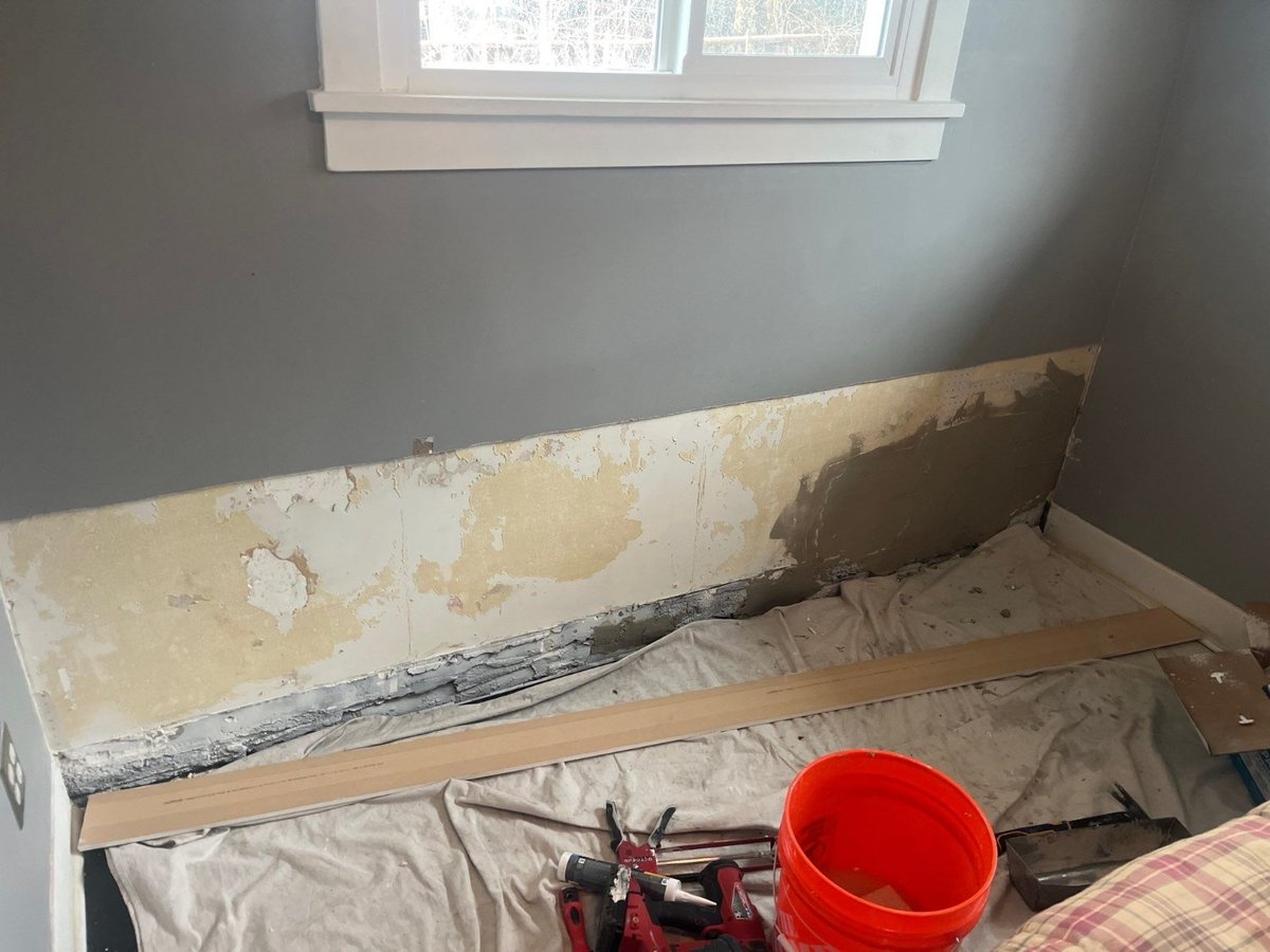 Water-damaged bedroom wall opened for repair during RemodelCo remodeling project in Salt Lake City, UT.-optimized