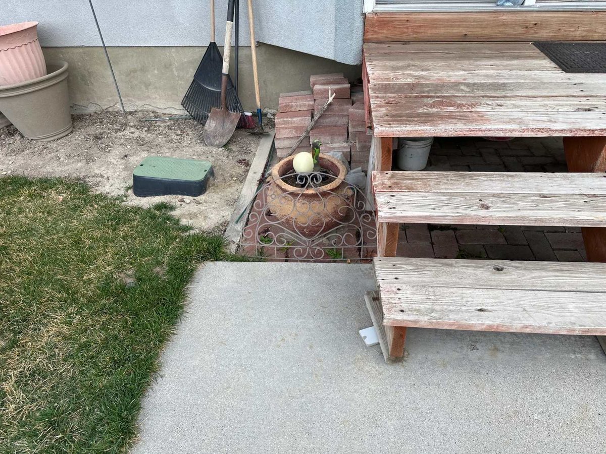 Close-up of an aging wood deck and landscaping before renovation by RemodelCo in Midvale, UT.-optimized