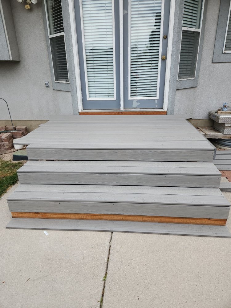 Front view of a new gray composite deck and stair renovation completed by RemodelCo in Midvale, UT.-optimized
