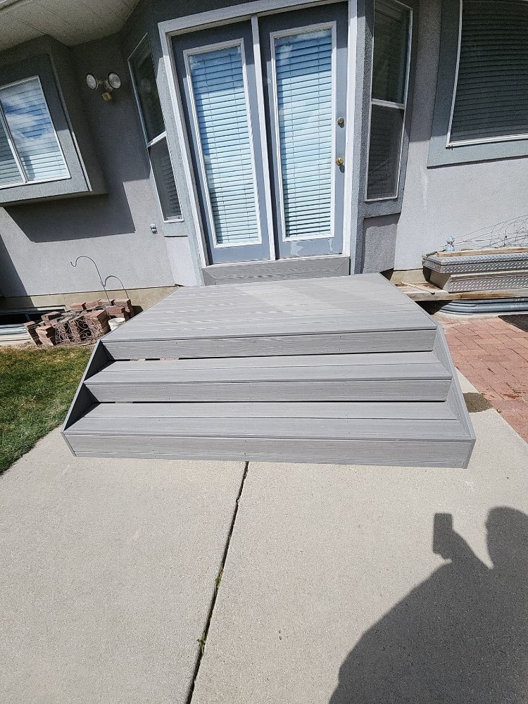 Front view of a newly completed composite deck and stair renovation by RemodelCo in Midvale, UT.-optimized