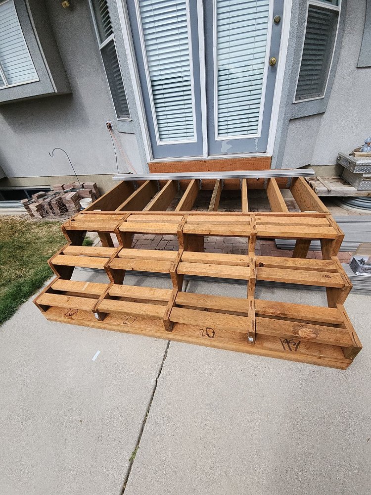 Front view of a newly framed deck and stairs before composite decking installation by RemodelCo in Midvale, UT.-optimized
