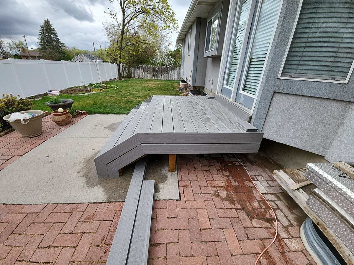New composite deck installation with integrated stair access by RemodelCo at a Midvale, UT home.-optimized