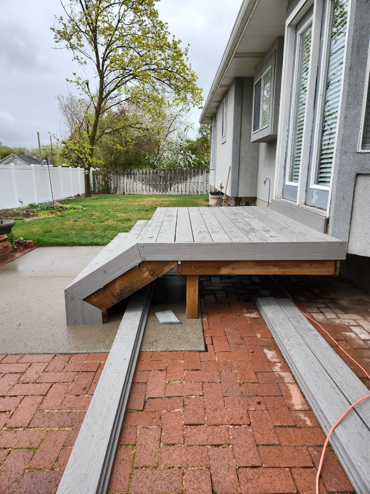 Side elevation of a newly installed composite deck and steps by RemodelCo in Midvale, UT.-optimized
