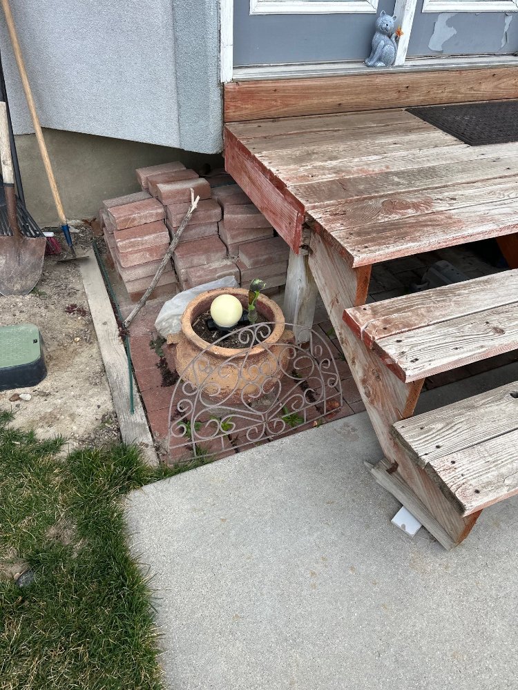 Side view of an aging backyard deck showing deteriorated wood before deck remodeling by RemodelCo in Midvale, UT.-optimized