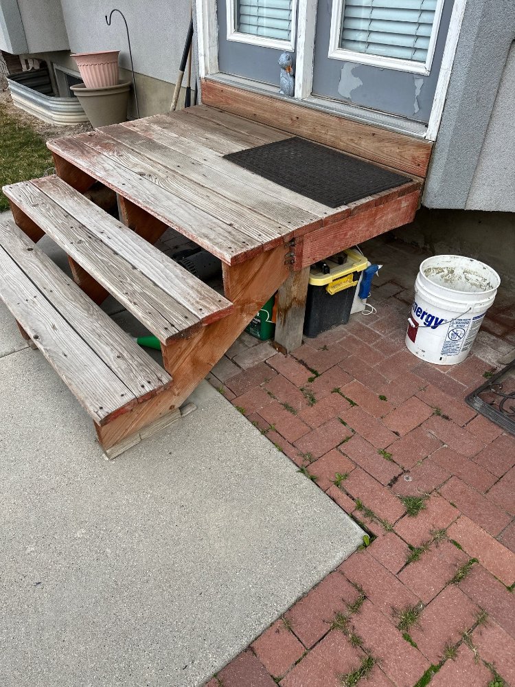 Weathered backyard deck and stairs before replacement during a deck remodeling project by RemodelCo in Midvale, UT.-optimized