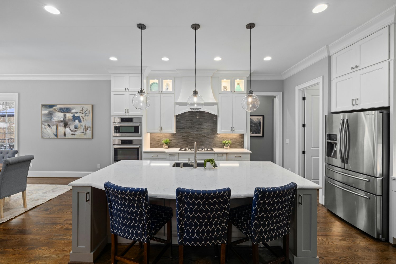 Open-concept kitchen with expansive island, custom cabinetry, and stainless steel appliances in a Sandy, UT kitchen remodel by R-optimized