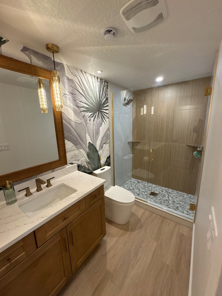 Stylish basement bathroom renovation featuring warm wood cabinetry and premium finishes completed by RemodelCo in Daybreak, UT.-optimized