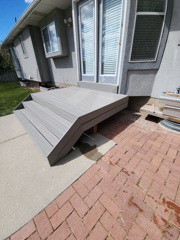 Angled view of a completed composite deck remodel by RemodelCo at a Midvale, UT home.-optimized