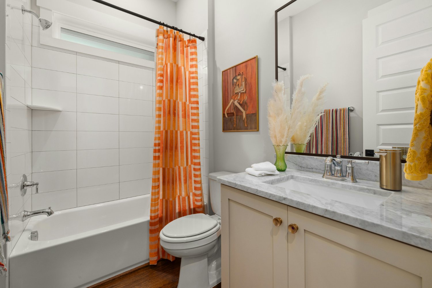 Guest bathroom with marble vanity countertop, tub shower combination, and decorative accents in a Sandy, UT bathroom remodel by -optimized