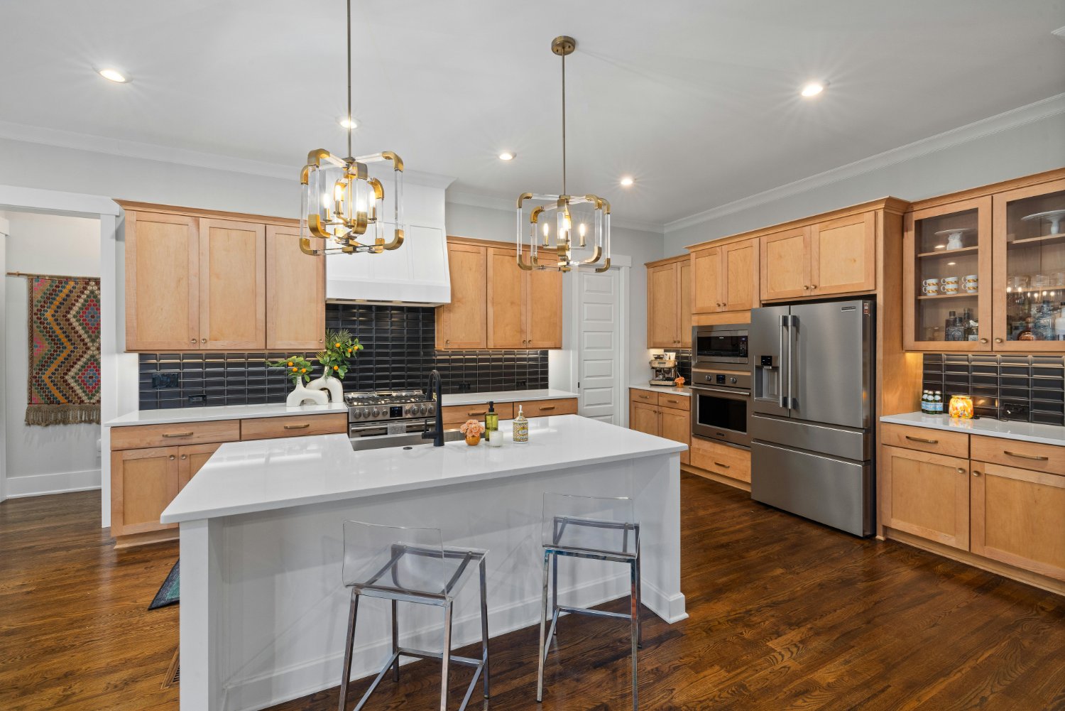 Spacious kitchen with statement lighting, custom storage, and contemporary design in a Sandy, UT remodel by RemodelCo stock-optimized