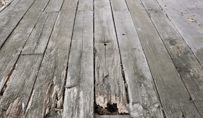 Image of a deck with rotting boards