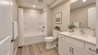 Bright compact basement bathroom with alcove tub