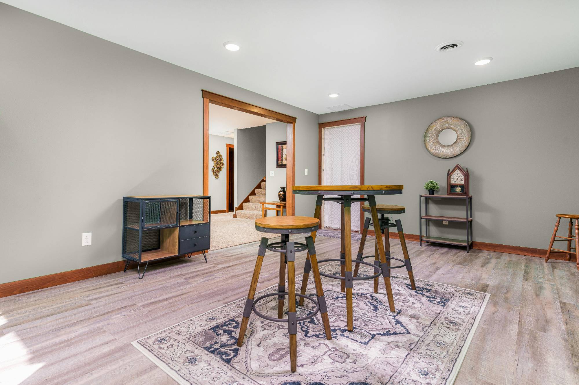 Basement game room with high-top table, luxury flooring, and open layout in a Sandy, UT basement remodel by RemodelCo stock-optimized