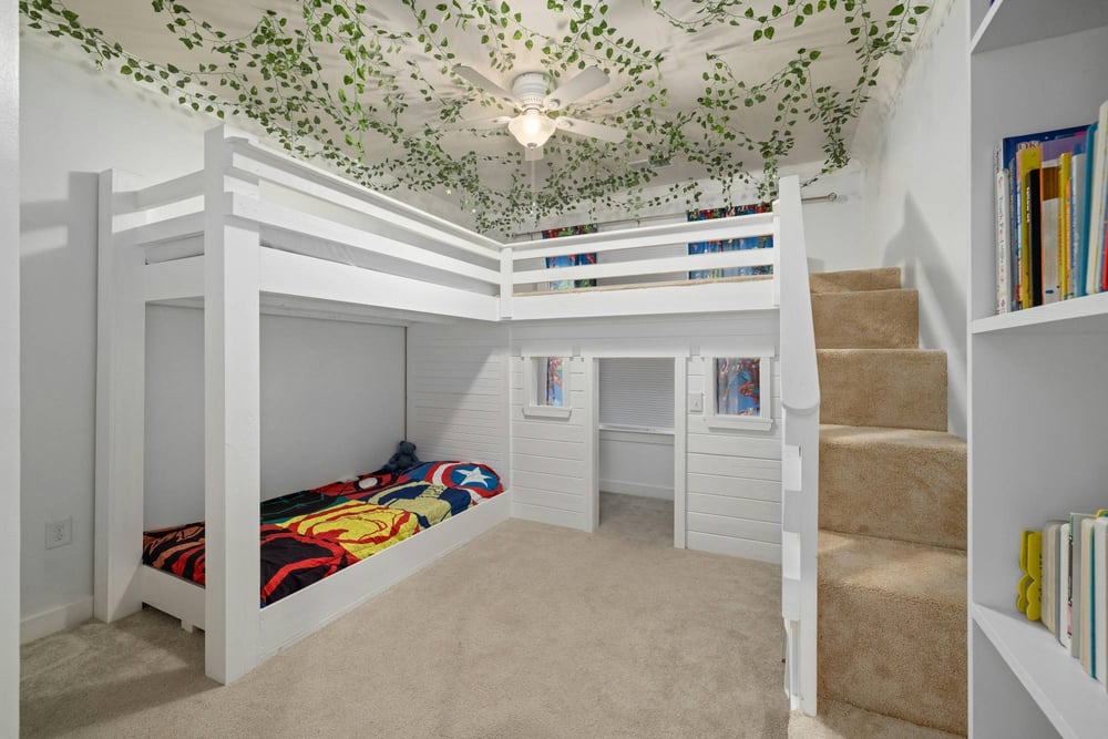 Basement sleeping space with custom loft structure and playful design elements in a Sandy, UT basement remodeling project by Rem-optimized