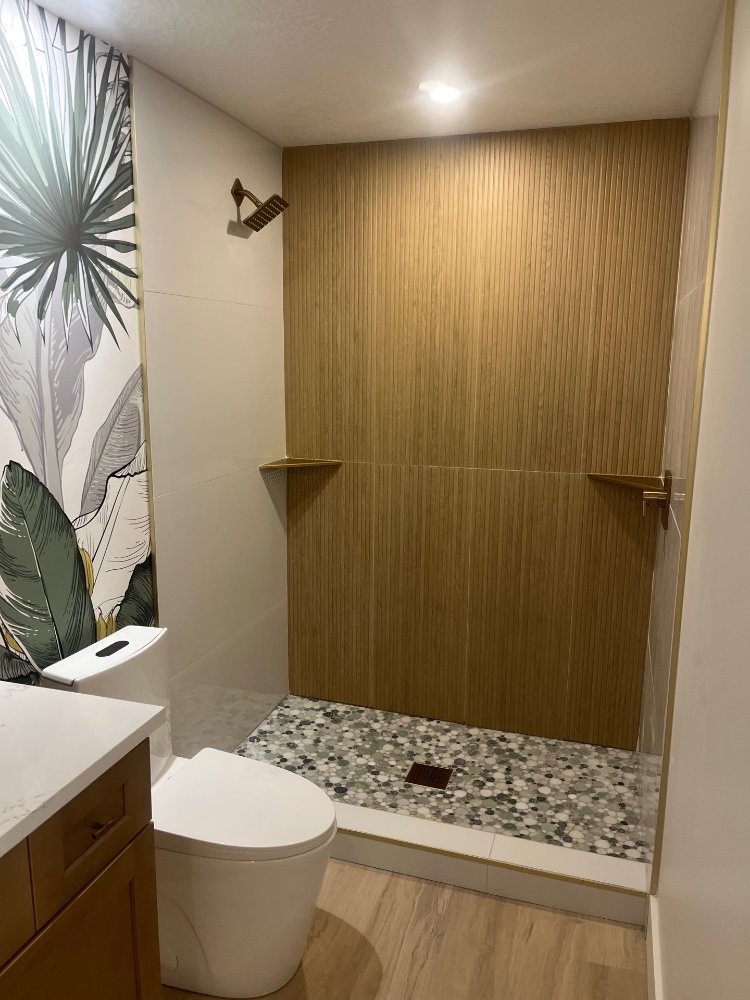 RemodelCo basement bathroom shower with wood-look tile and pebble mosaic flooring in Daybreak, UT.-optimized