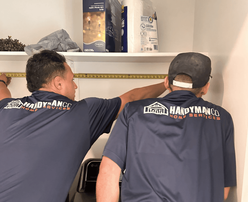 Image of employees measuring a space as part of a remodel