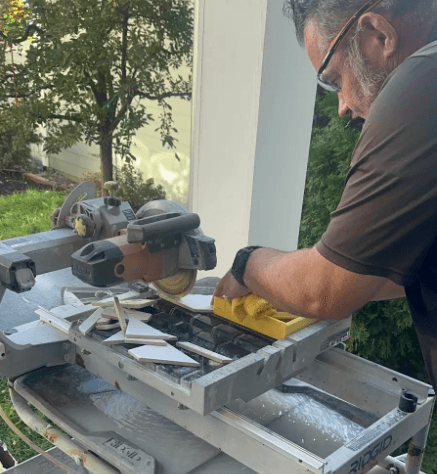 Image of a man working on wood pieces of a deck