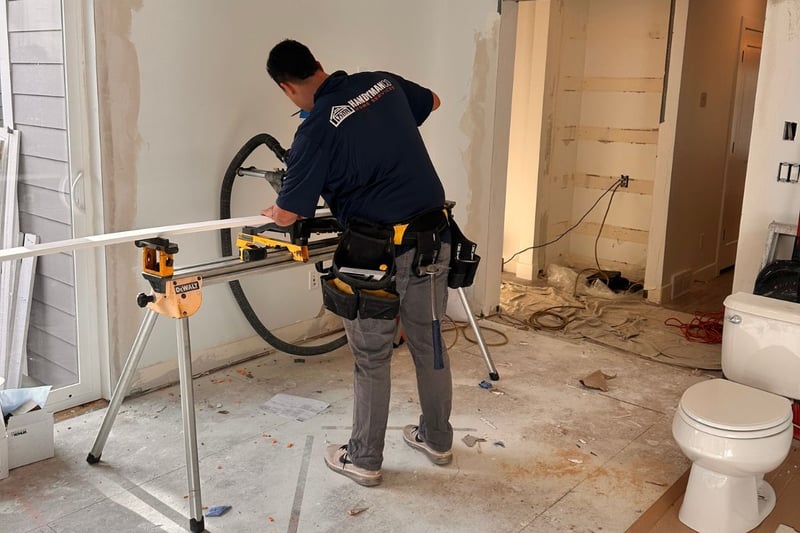 Image of a RemodelCo employee working on a bathroom remodel