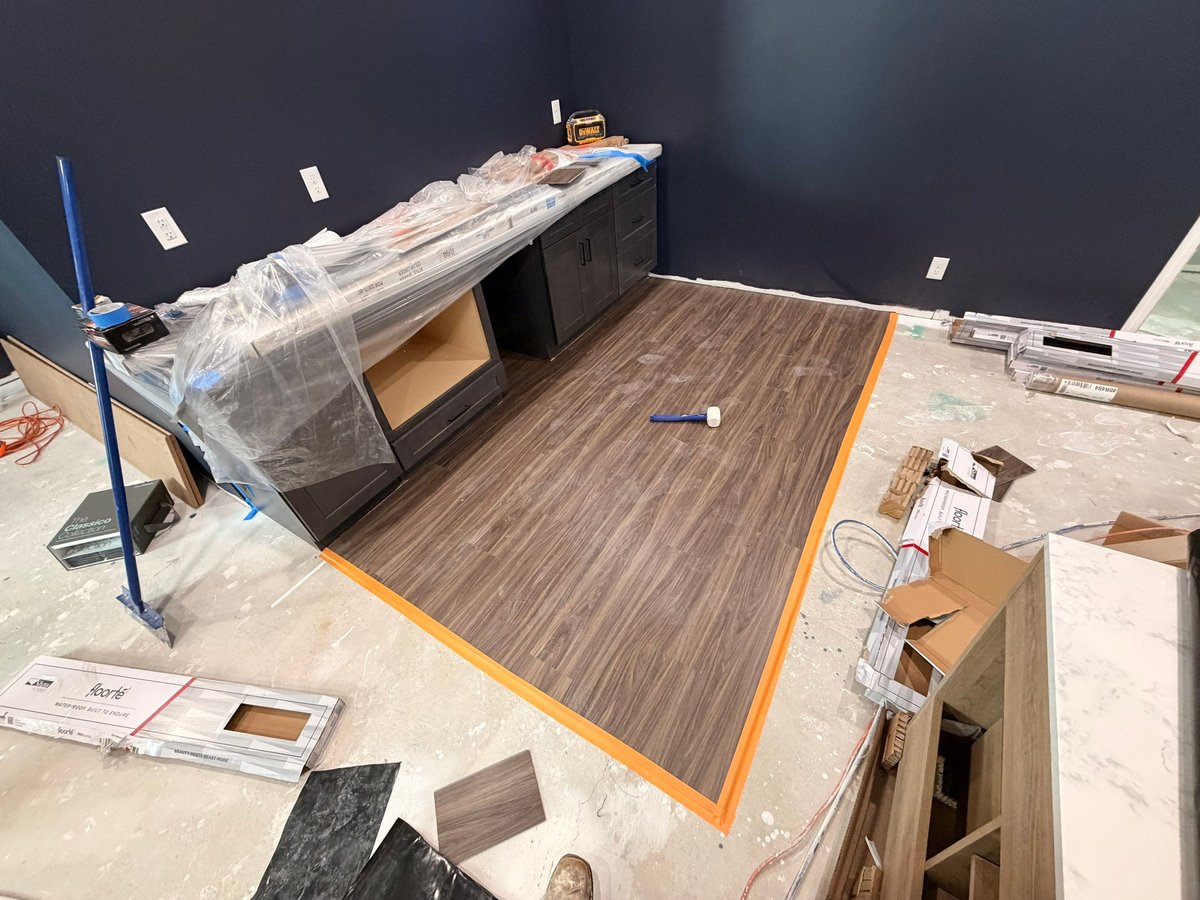 Luxury vinyl plank flooring installation around a custom basement wet bar in Herriman.