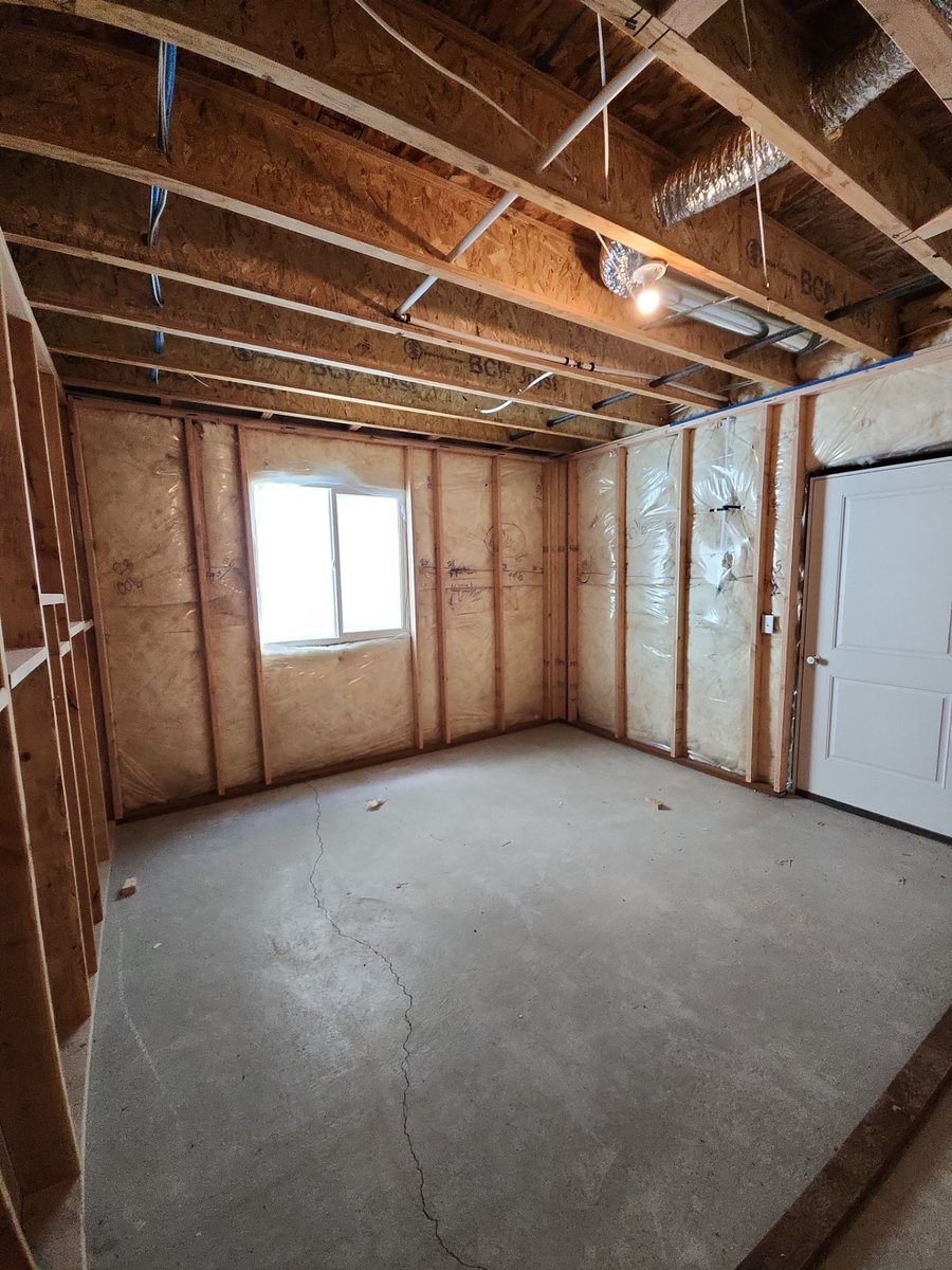 Open basement framing and insulation before drywall installation in Herriman, Utah.