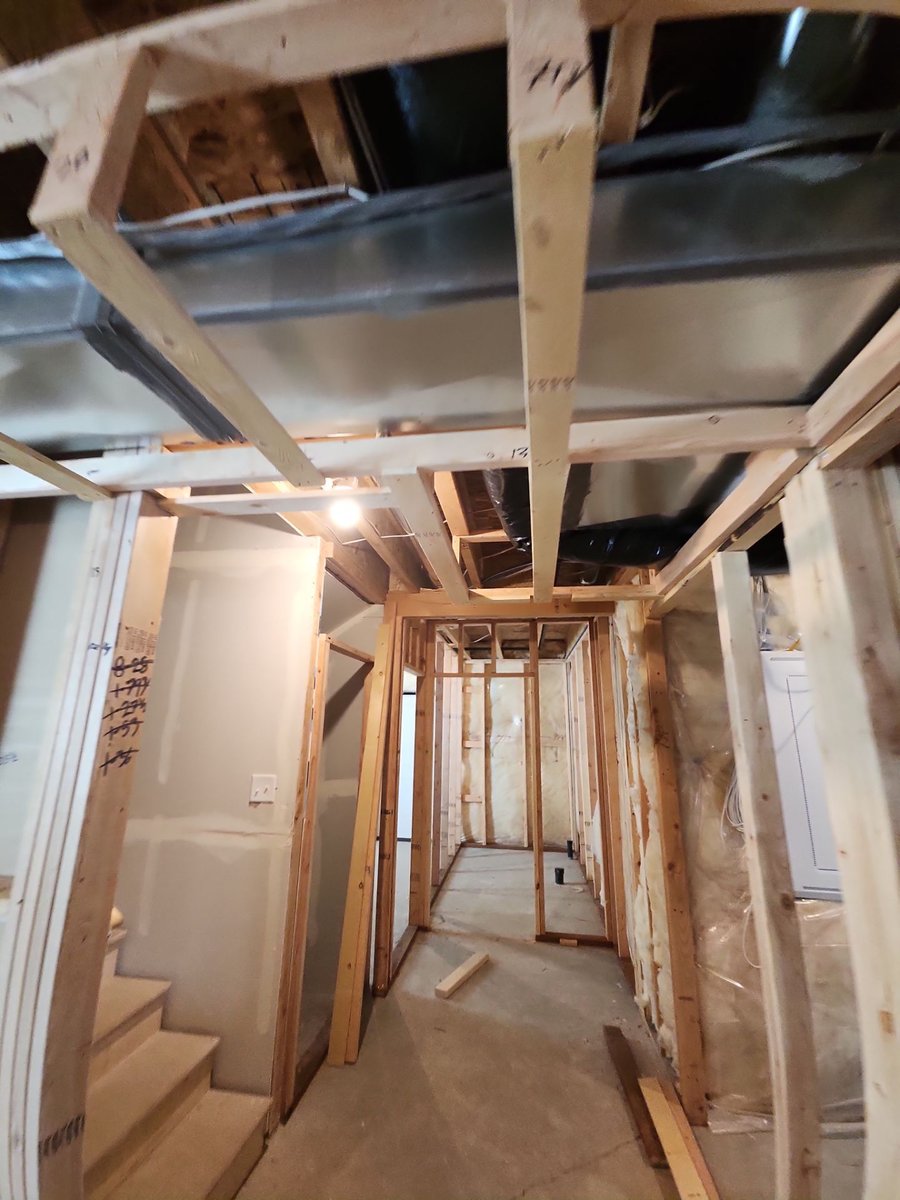 Basement hallway framing with HVAC ductwork during construction in Herriman.