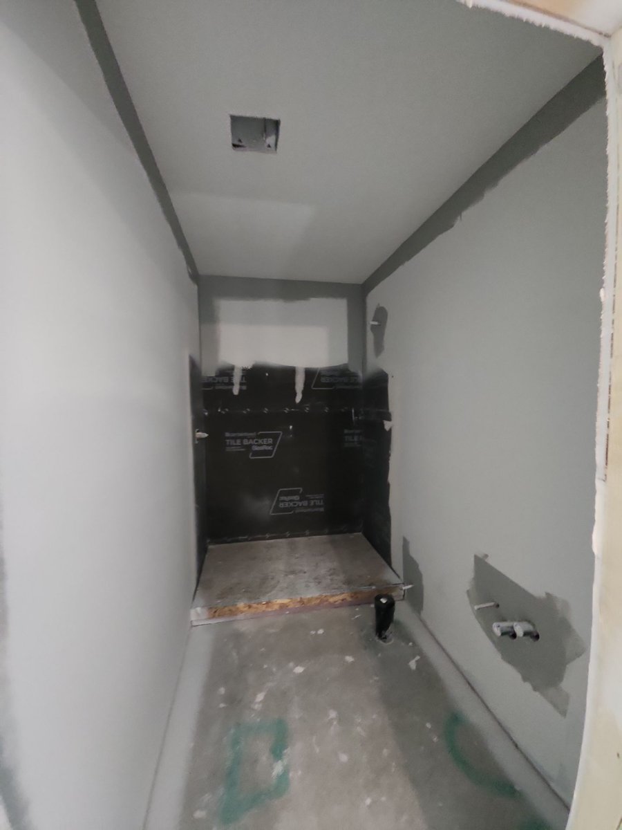 Shower waterproofing installation during a basement bathroom finish in Herriman, Utah.